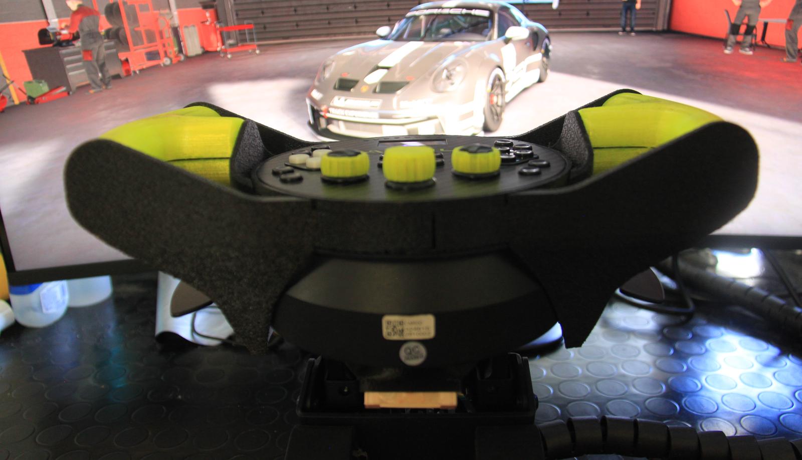 The wheel from behind, in front of the sim on screen