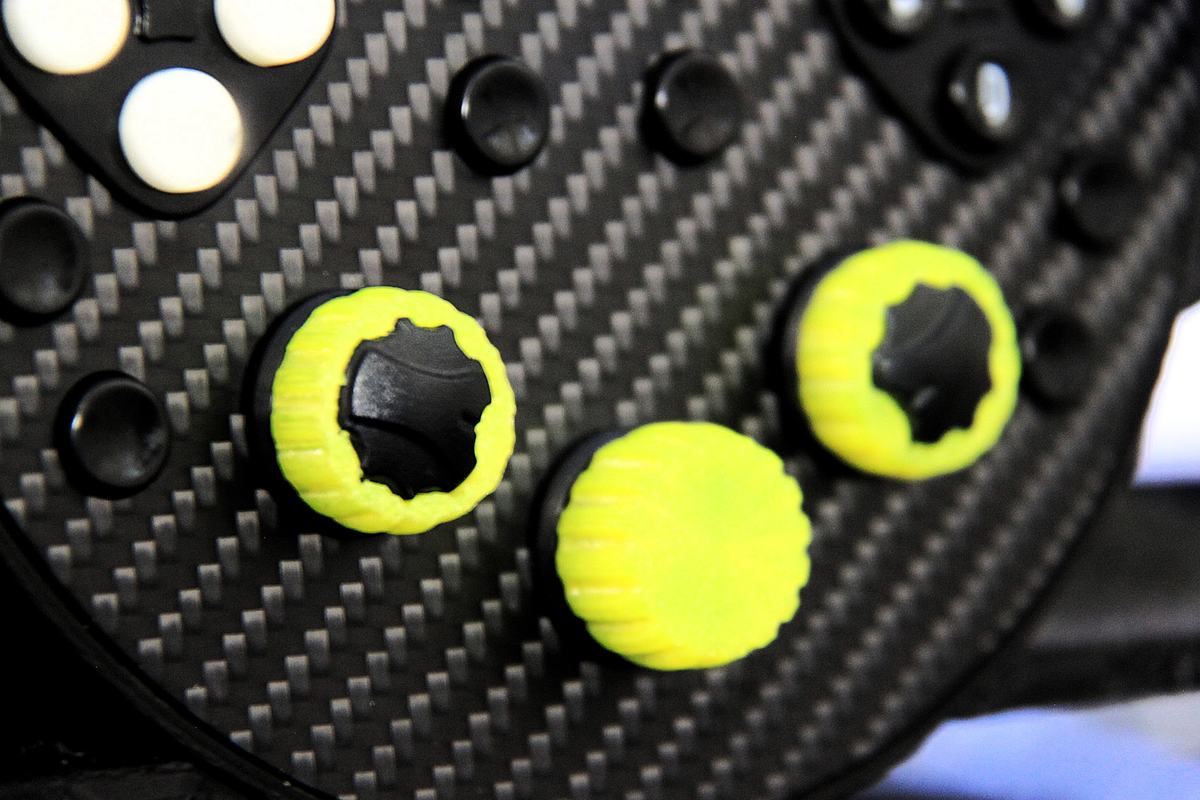 Close-up of the lime knob caps on the carbon face